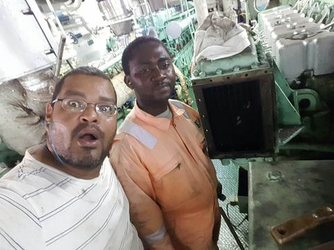 Two crew members in a vessel engine room