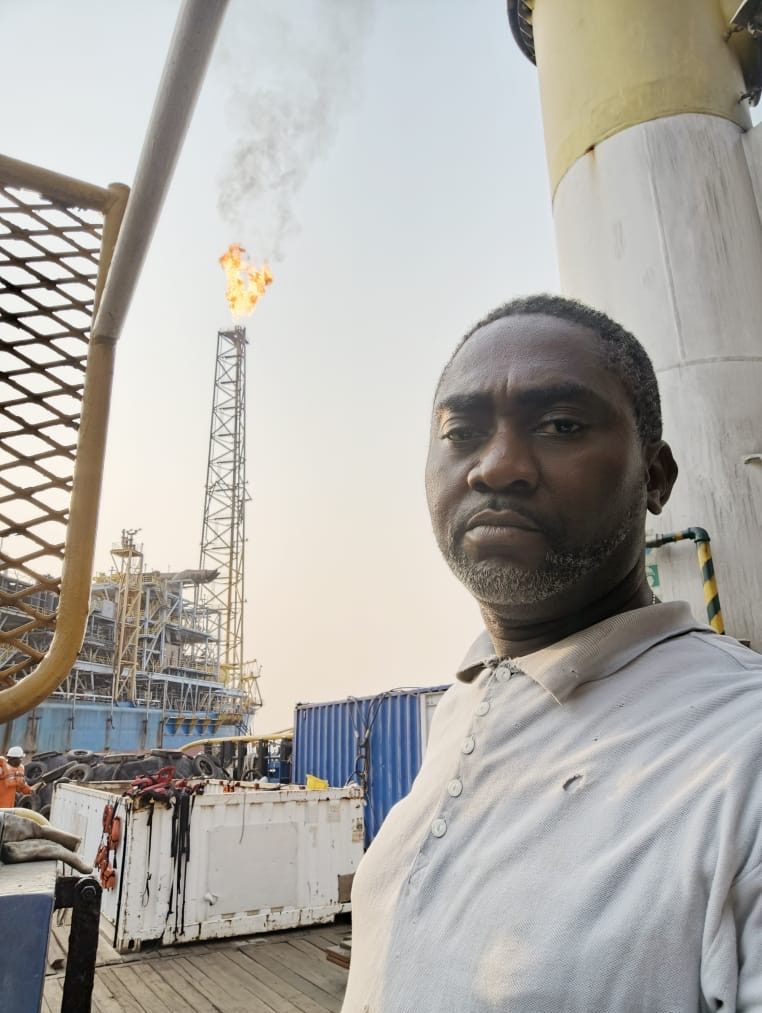 Eddy (Edirin), founder of Omodelight Technical, offshore beside a flare stack