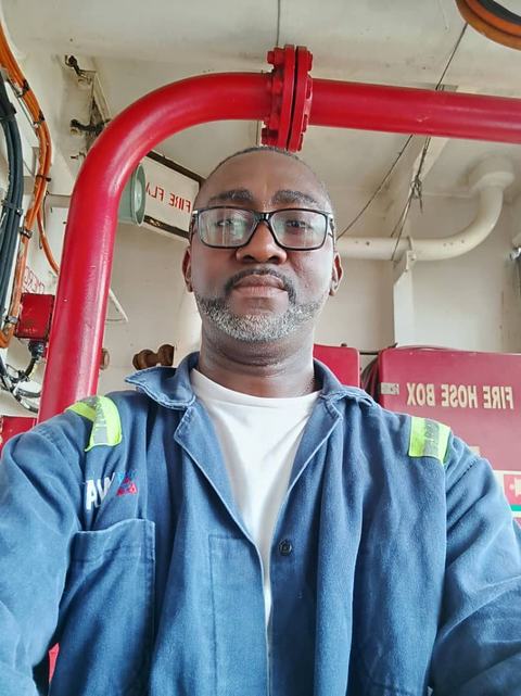 Eddy beside a red fire main and fire hose box