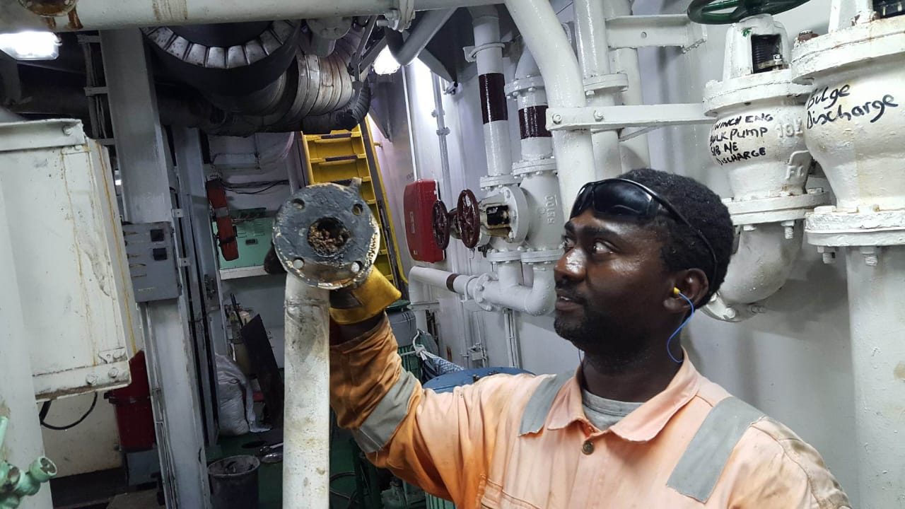 Technician working on engine room pipework