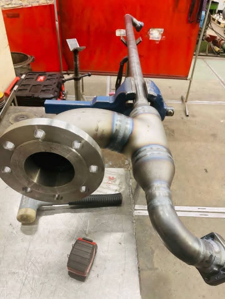 Fabricated steel pipe assembly with a flange