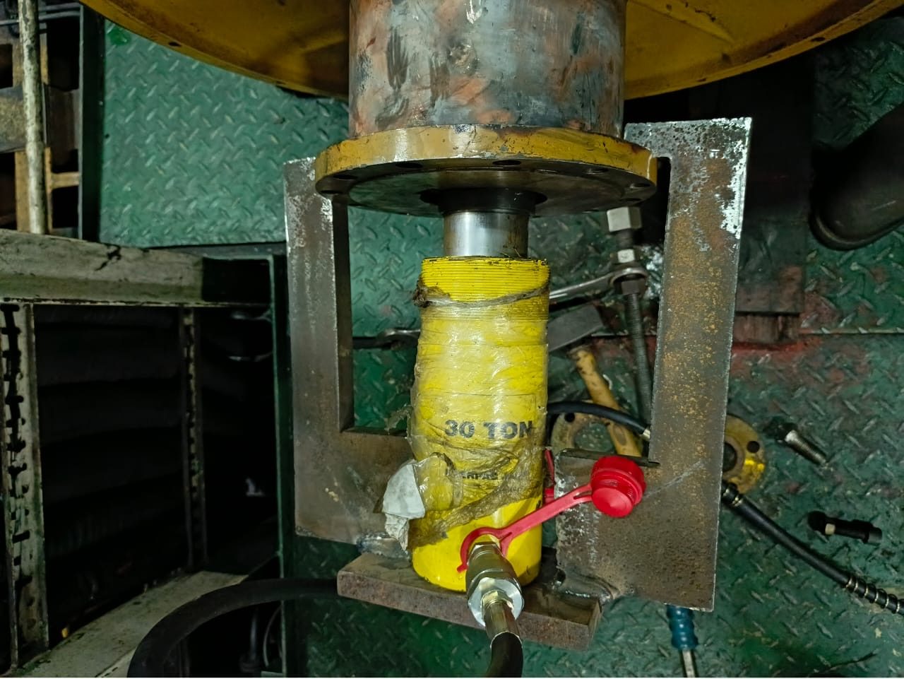 A 30-ton hydraulic jack set up under a steel load