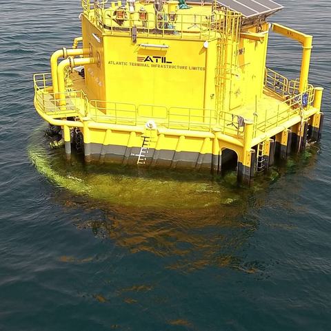 Yellow ATIL mooring buoy at an offshore terminal