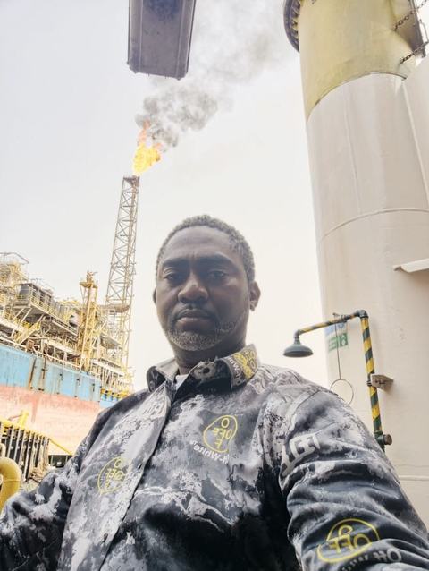 Eddy offshore with an FPSO flare tower behind him